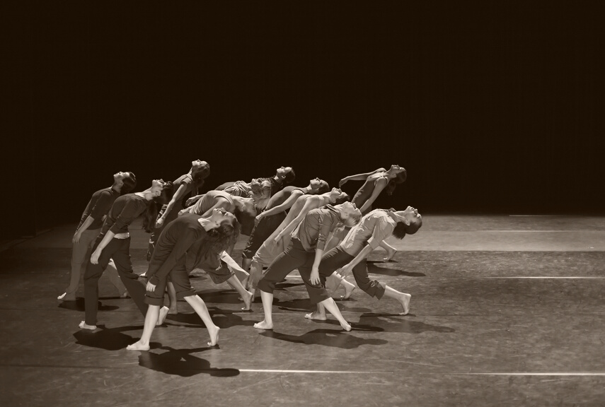 Group of contemporary dancers performing on stage