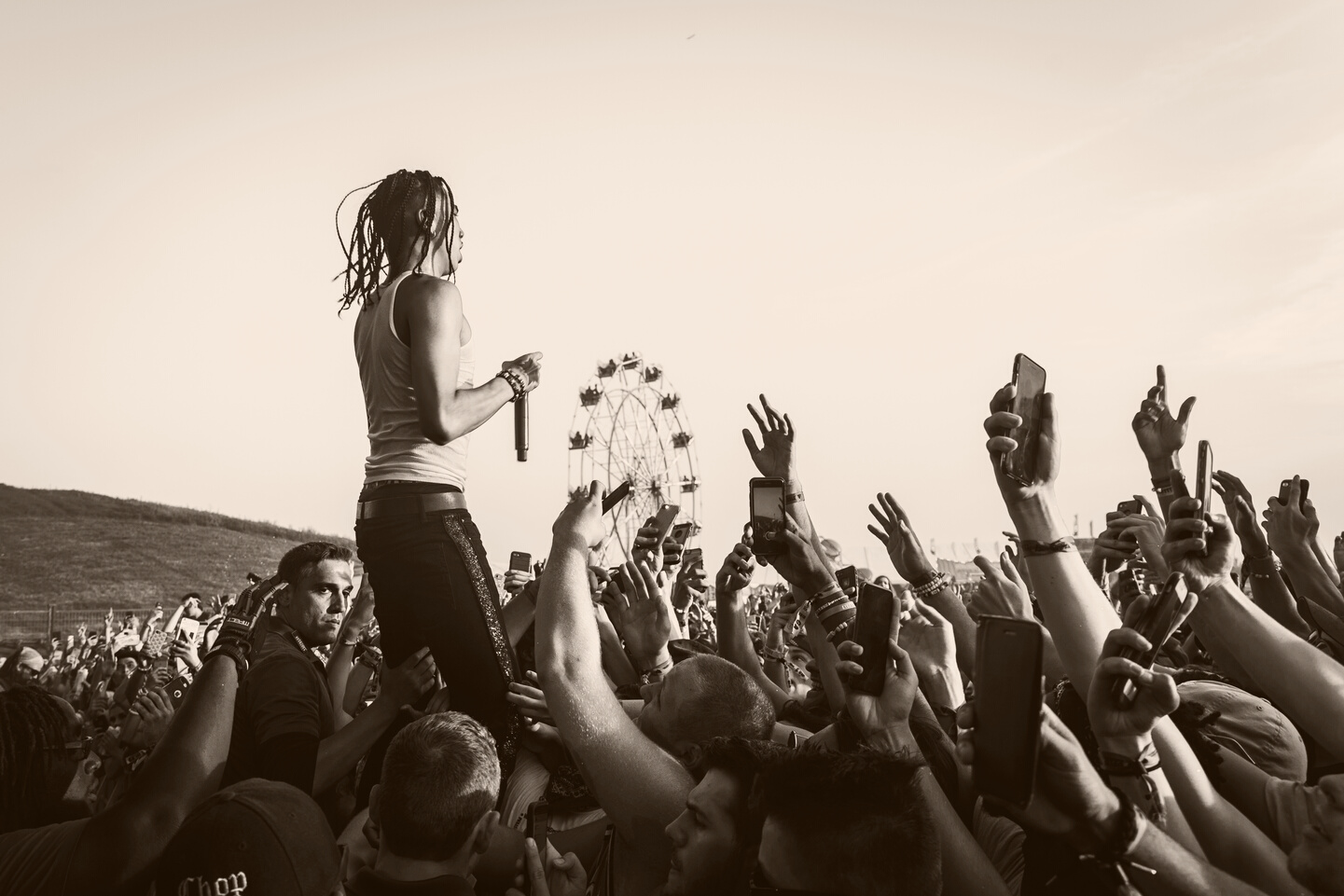 Man Holing Microphone In Front Of Crowd